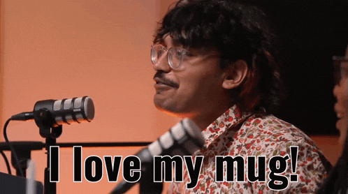 a man wearing glasses and a floral shirt says " i love my mug "