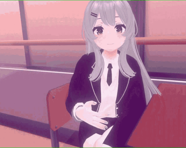 a girl in a suit and tie is sitting on a red chair