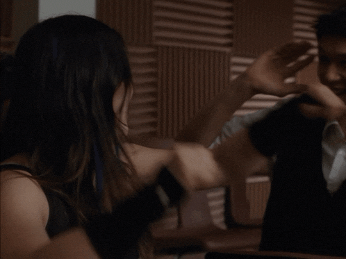 a man giving a woman a high five with his hands