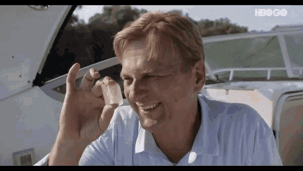 a man on a boat holding a piece of ice with hbo go written on the bottom right