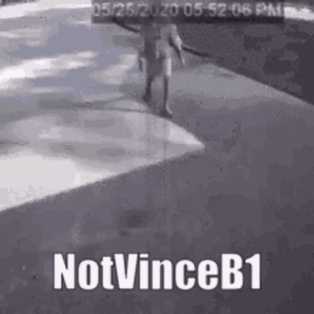 a person is walking down a sidewalk with the words `` notvinceb1 '' on the bottom .