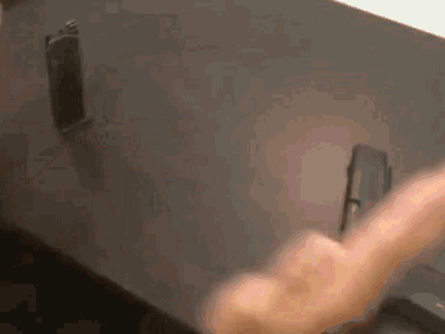 a close up of a person 's hand holding a phone