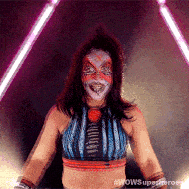 a woman with a clown face painted on her face is standing in front of purple lights
