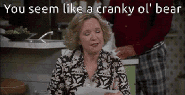 a woman holding a piece of paper with the words you seem like a cranky ol ' bear