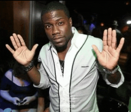 a man in a white shirt is holding his hands up