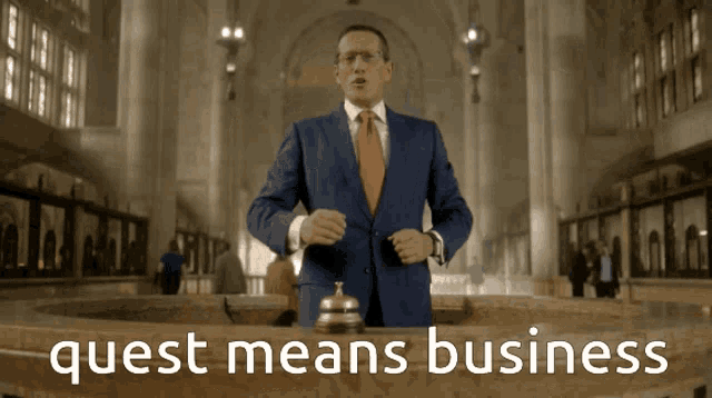 a man in a suit and tie stands in front of a sign that says " quest means business "