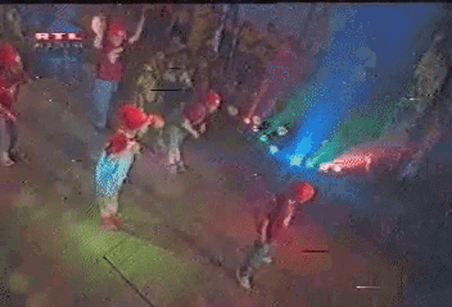 a person wearing a red shirt that says rtl on the front