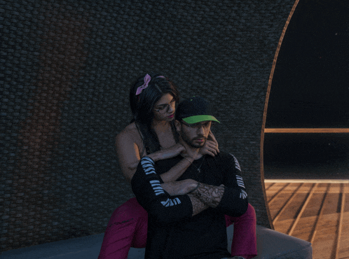 a woman sits on a man 's shoulders wearing a black shirt that says " i love you "