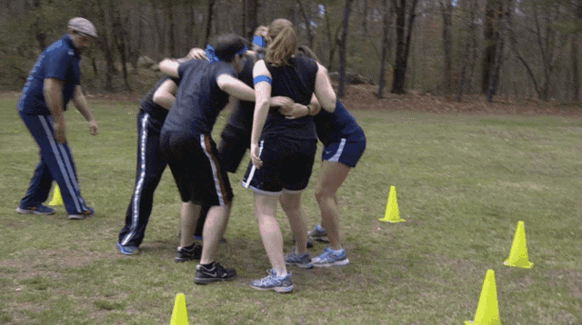 a group of people are huddled together in a field