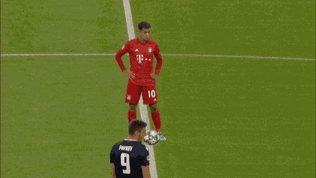 a soccer player with the number 10 on his jersey stands on the field