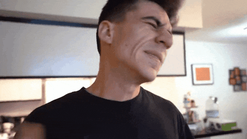 a man making a funny face with his eyes closed