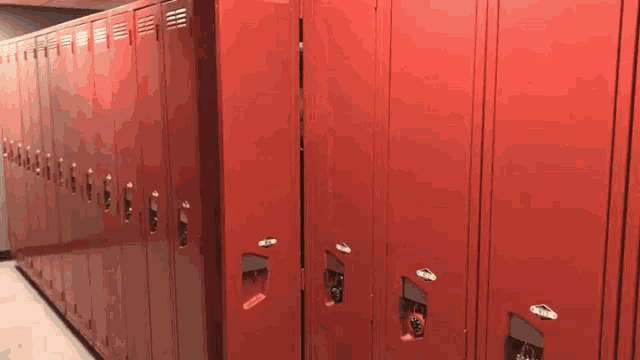 a row of red lockers are lined up in a row