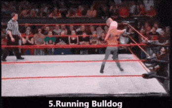 a woman is wrestling a man in a wrestling ring with the words running bulldog below her