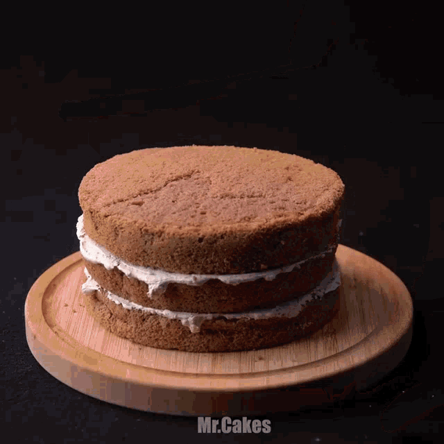 a cake on a wooden cutting board that says mr. cakes