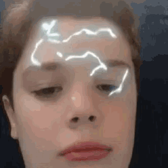 a close up of a person 's face with lightning bolts on it .