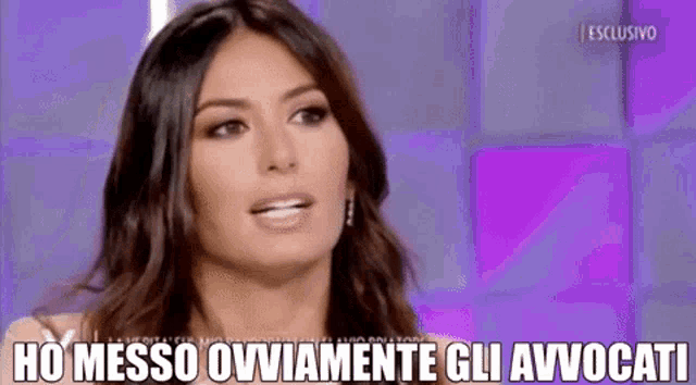 a woman is talking on a television show and the words ho messo ovamente gli avvocati are above her .