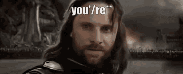 a man with a beard is looking at the camera with the words `` you 're '' above him .