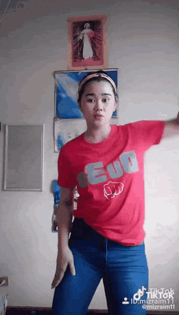 a woman wearing a red shirt that says euo