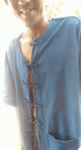 a man wearing a blue shirt with buttons on it