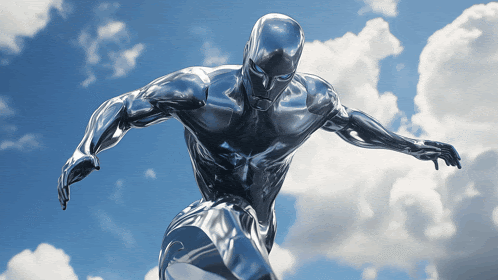 a statue of a silver superhero is flying in the sky