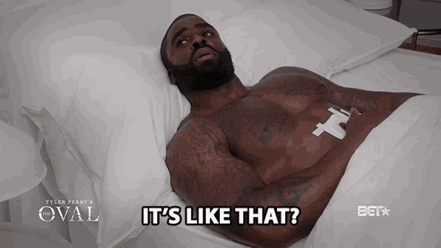 a shirtless man is laying in a bed with the words it 's like that