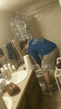 a man in a blue shirt that says ' st. louis ' on it