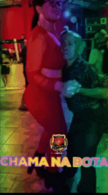a woman in a red dress is dancing with a man in a dark room and the words chama na bota are visible
