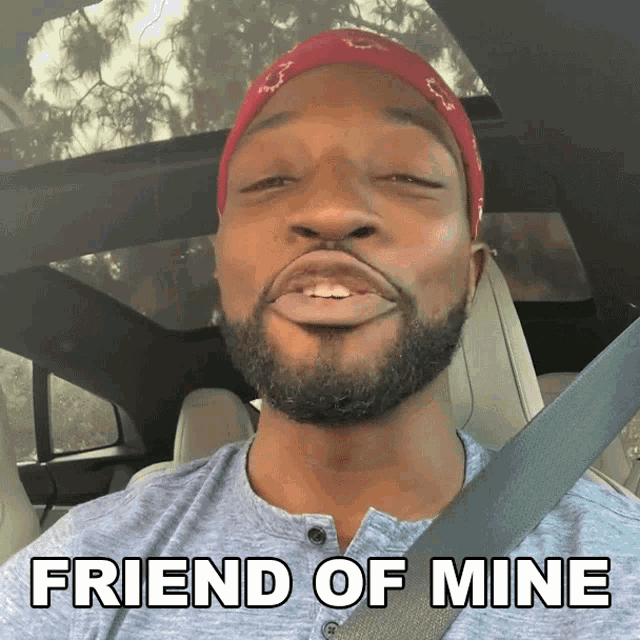 a man sitting in a car with the words friend of mine on the bottom