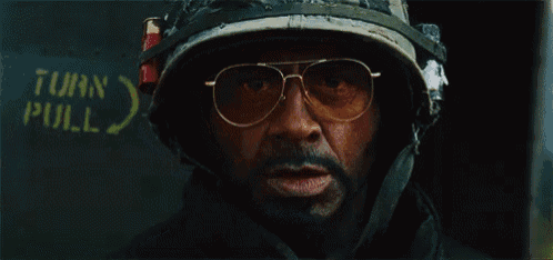 a man wearing a helmet and glasses says survive