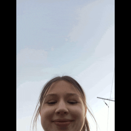 a girl with a blue sky in the background