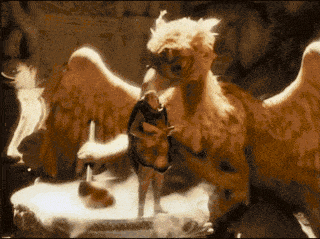 a man is standing next to a large winged animal