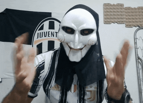 a man wearing a juvent shirt and a mask