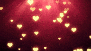 a bunch of hearts are flying in the air on a red background