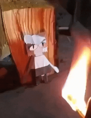 a person is burning a piece of paper that looks like spongebob squarepants .