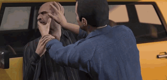 a man in a blue shirt is putting his hand on another man 's forehead