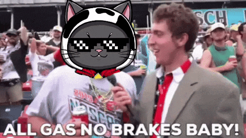 a man in a suit and tie is talking into a microphone with a cat on his head saying all gas no brakes