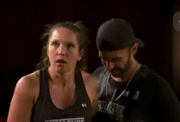 a woman wearing a black tank top that says challenge on it