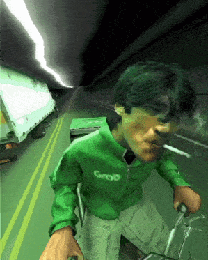 a man in a green groo jacket is smoking a cigarette while riding a bike