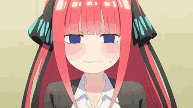 a girl with red hair and blue eyes making a face