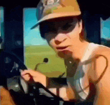 a shirtless man wearing a hat with the letter j on it