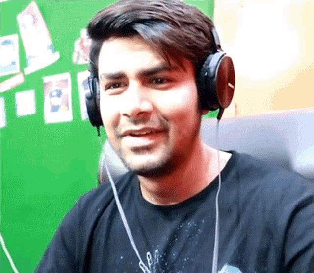 a man wearing headphones and a black shirt