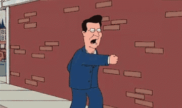 a man in a suit and tie is standing in front of a brick wall with the word rheygon written on it