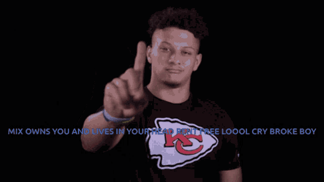 a man wearing a t-shirt with a kc logo on it