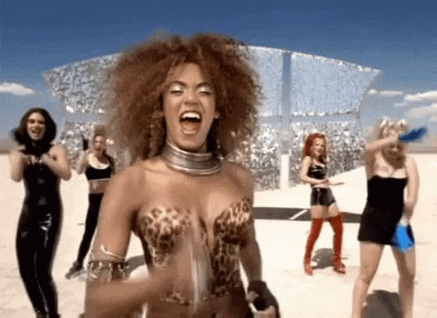 a woman in a leopard print top is standing in front of a group of women .