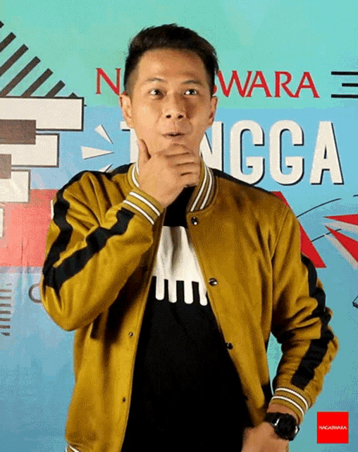a man in a yellow jacket is standing in front of a wall that says ngga