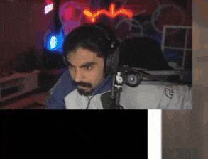a man wearing headphones is sitting in front of a computer