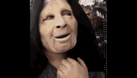 a person in a mask is being attacked by a monster .