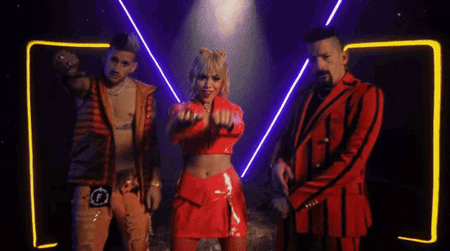 a woman in a red outfit is dancing with two men