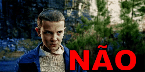 a girl in a blue jacket stands in front of a sign that says não
