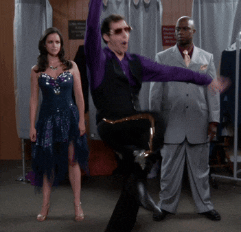 a man in a purple shirt is dancing with a woman in a blue dress